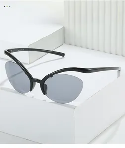 Detail of Y2K cat-eye sunglasses with sleek black frame and CE mark on inner temple