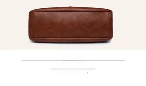 Detail view of the reinforced stitching and smooth leather texture on the bag's bottom