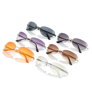 Modern rimless cat eye sunglasses in multiple colors on a white reflective background