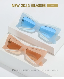 Close-up of blue and pink butterfly-shaped PC frame sunglasses on white display blocks