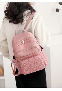 Detailed back view of women's pink quilted backpack in fashion commuter style