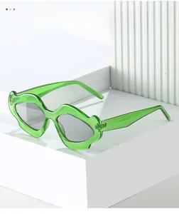 Detailed view of green transparent mustache-shaped sunglasses on white geometric podium