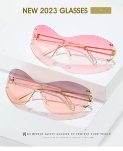 Detail of Y2K rimless sunglasses with pink gradient lenses and gold metal rivets