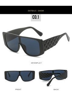Detail view of large frame sunglasses featuring embossed quilted texture on temple arms