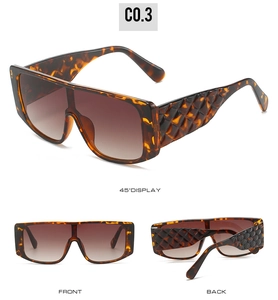 Detailed view of oversized tortoiseshell flat top sunglasses with gradient lenses and quilted temples