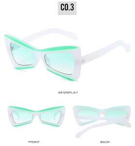 Three-way view of white triangle butterfly sunglasses with green accents and lenses