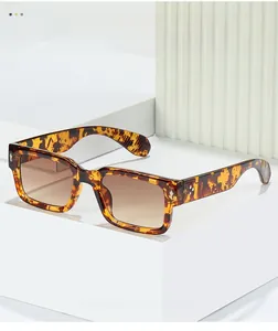 Close-up of retro tortoise shell rectangular sunglasses with brown gradient lenses