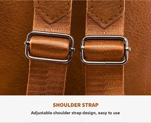 Close-up of brown leather backpack shoulder strap with adjustable silver metal buckle