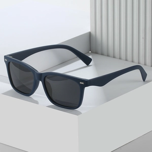 Matte navy blue square polarized sunglasses for men on architectural geometric stand
