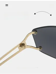 Detail of durable gold metal hinges and dark grey lenses on Y2K rimless sunglasses