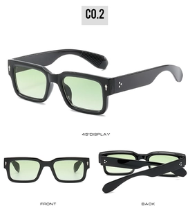 Detail view of black square sunglasses with mint green lenses and metal rivet accents
