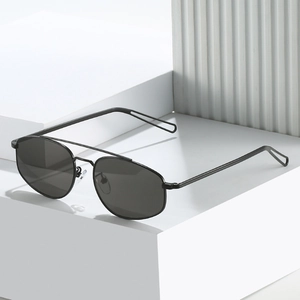Classic black pilot metal sunglasses with matte frame on a minimalist geometric pedestal
