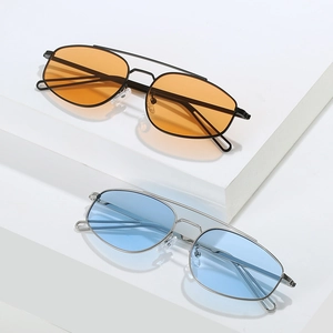 Classic aviator metal sunglasses with colorful lenses on minimalist white steps