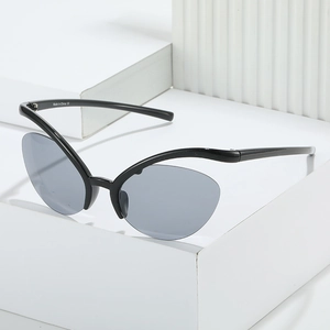 Y2K style cat eye sunglasses with sleek black frame and gray lenses on a white pedestal