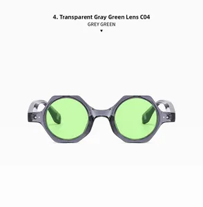 Detail view of hex frames in transparent grey with green lenses and decorative metal pins