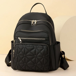 Chic black quilted nylon backpack with gold zippers for women's urban commuting