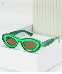 Detail of green transparent thick frames with oval brown lenses and texture material