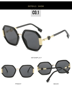 Detail view of oversized hexagonal sunglasses with gold metal temples and striped engraving