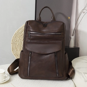 Deep brown vintage leather backpack with multiple pockets for travel and outdoor use