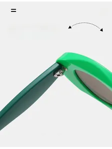 Detail of durable silver metal hinge on contrasting green frame trendy sunglasses