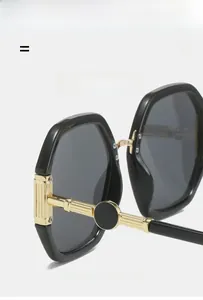 Detail of golden metal hinge with texture on polygonal black frame sunglasses