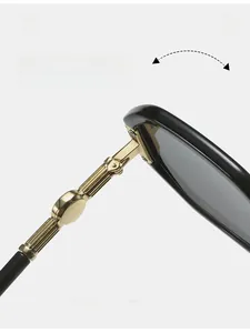 Detail view of durable gold metal hinges and black polished temples of polygon sunglasses