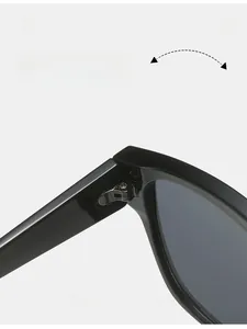 Detailed close-up of a durable metal hinge on stylish oversized black sunglasses