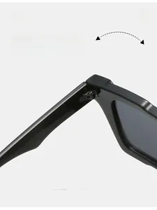 Close-up of durable metal hinge on black square sunglasses with smooth high-gloss finish