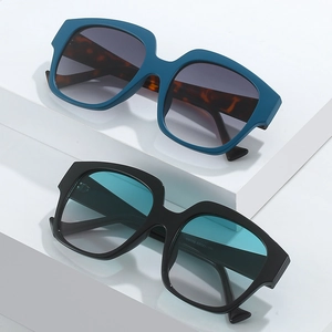 Modern oversized square sunglasses for women with blue and black frames and UV400 lenses