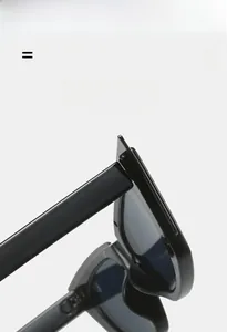 Detailed view of lightweight, super elastic hinges on high-gloss black cat-eye sunglasses