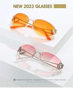 Detail of rimless sunglasses with heart-shaped metal accents and gradient lenses