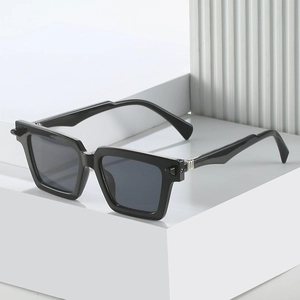 Modern black square sunglasses with grey lenses and silver accents on 45-degree angle