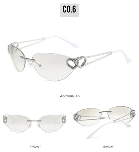 Three-angle view of rimless heart-shaped sunglasses with silver metal frame and gray lenses
