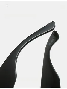 Detail of curved ergonomic black sunglasses legs with compliance markings and sleek finish