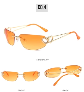 Détails des lunettes de soleil sans monture avec dégradé orange et branches cœur dorées