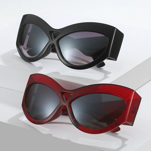 Oversized cat eye sunglasses with thick frames in black and translucent deep red