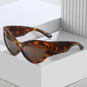 Chic cat eye leopard print sunglasses with brown lenses on minimalist display