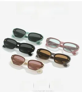 Close-up of stylish square sunglasses in multiple colors with metallic rivet accents