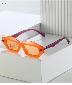 Detailed macro view of orange geometric sunglasses frames with thick material texture