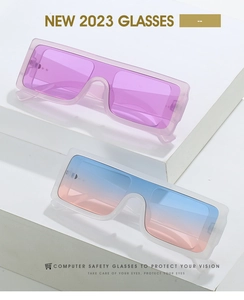 Close-up of stylish oversized candy-colored sunglasses on clean geometric pedestals