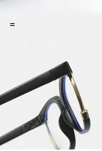 Detail of black eyeglass frame featuring golden metal hinges and blue light coating