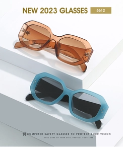 Detail of stylish polygon safety glasses with rivets in amber and matte blue colors