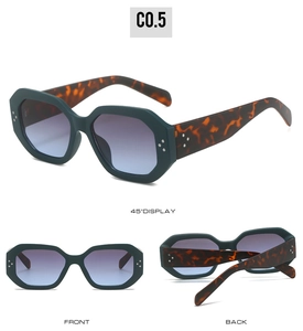 Detail of dark green hexagonal sunglasses with classic tortoiseshell temples and metal rivets