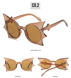 Three views of bat-wing shaped sunglasses in translucent tea color showing all angles