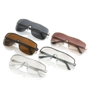 Oversized rimless shield sunglasses set in black, brown, and clear gradient lenses