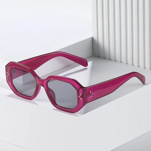 Fashionable rose pink transparent geometric sunglasses with rivets and grey lenses