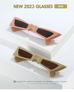 Detail of trendy thick-frame butterfly sunglasses on minimalist white display blocks