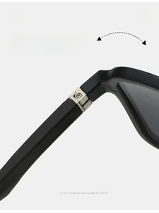 Detail of durable silver metal hinges on matte black sunglasses with folding test
