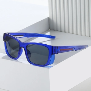 Sporty blue translucent sunglasses with grey lenses on a white geometric platform