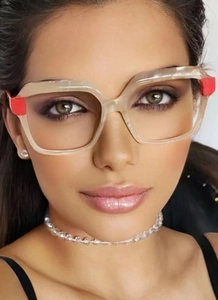 Close-up of translucent oversized square glasses with red color-block detail on a model